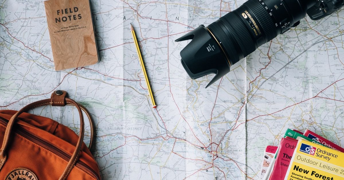 World map on table with passports and travel documents — preparing for a US visa interview
